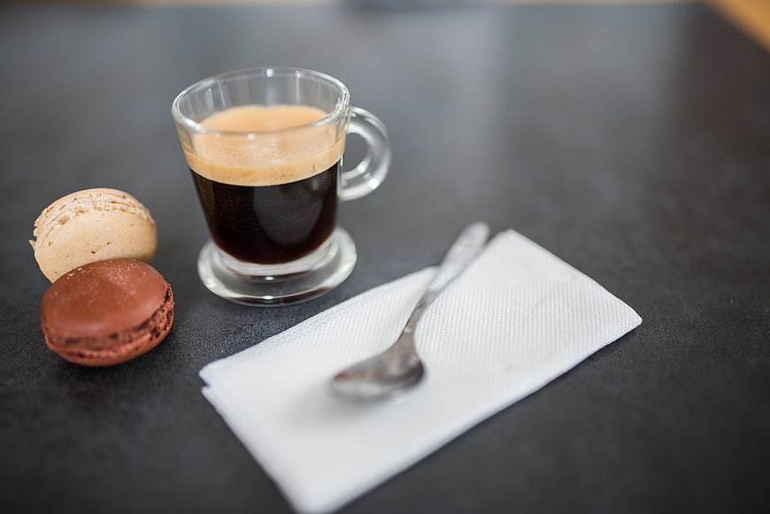 Espresso Coffee and Macarons on Dark Table