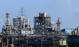 Petrochemical refinery complex with industrial pipes and towers