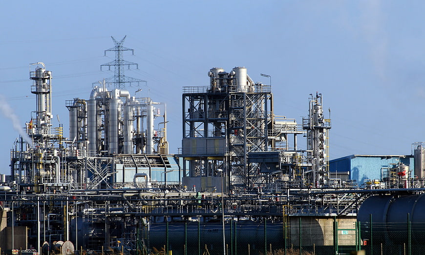 Petrochemical refinery complex with industrial pipes and towers