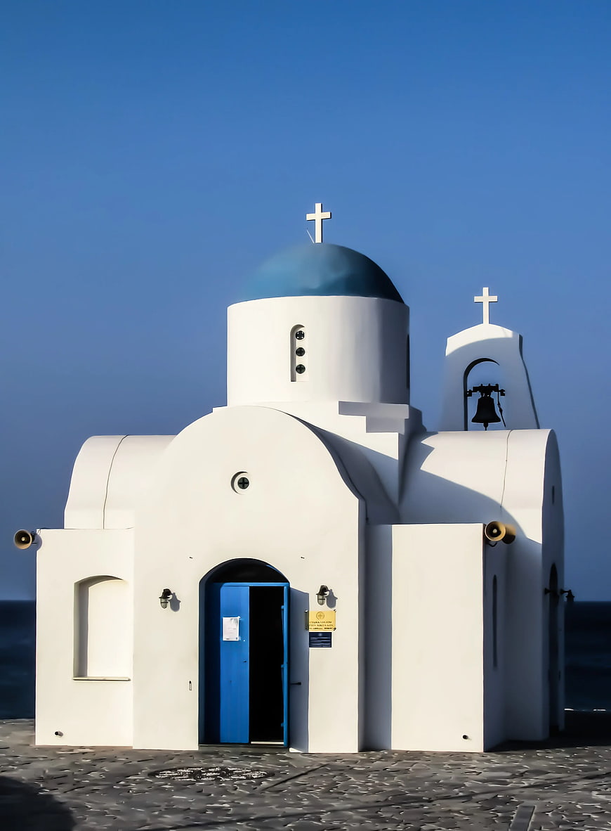Iconic White and Blue Greek Orthodox Church by the Sea