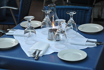 Elegant blue table setting with wine glasses and candle