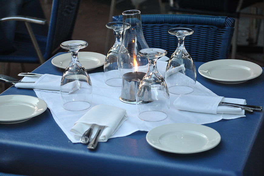 Elegant blue table setting with wine glasses and candle