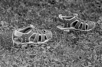 Black and White Photo of Toddler Sandals on Grass