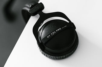 Close-up of black DT 770 Pro headphones on white surface