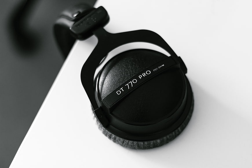 Close-up of black DT 770 Pro headphones on white surface