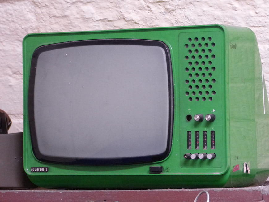 Vintage Green CRT Television Set Against White Wall