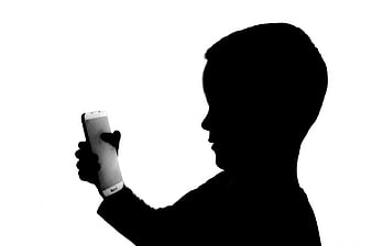 Silhouette of Boy Holding Smartphone on White Background