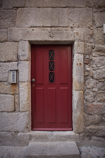 Red Wooden Door in Old Stone Wall Architecture