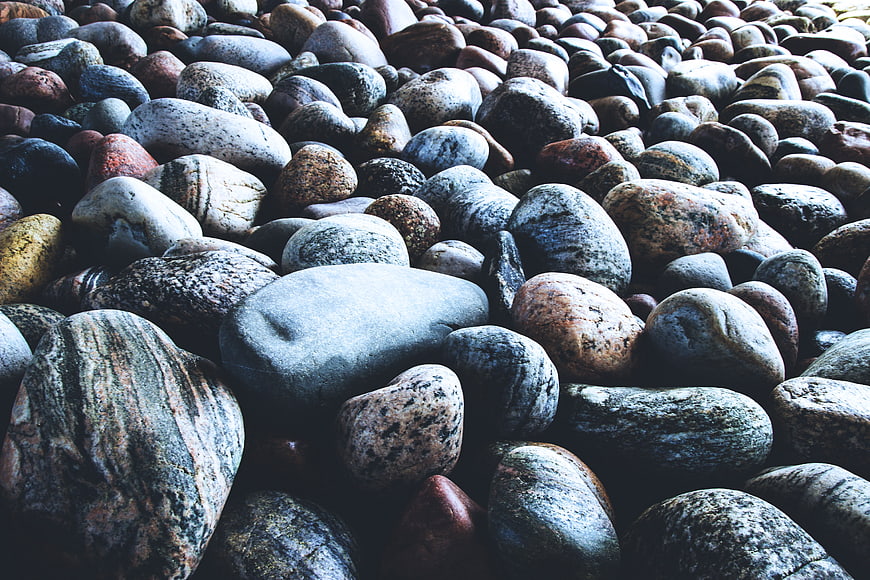Close-up of smooth wet pebbles on a rocky beach