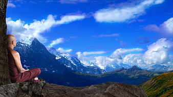 Buddhist monk meditating on a rocky mountain peak with snow-capped peaks and blue sky
