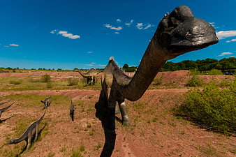 Dinosaur Model Sculpture In Outdoor Park Landscape