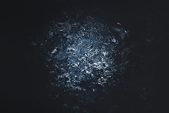 Dark blue water splash with bubbles on black background