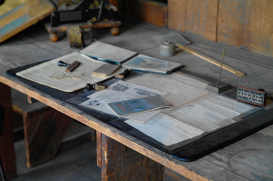Vintage printing press workspace with old papers and tools