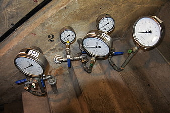 Industrial pressure gauges mounted on concrete dam wall
