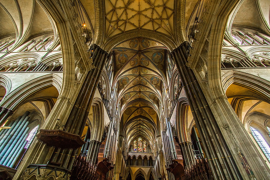 Gothic Cathedral Interior with Vaulted Ceilings and Stained Glass