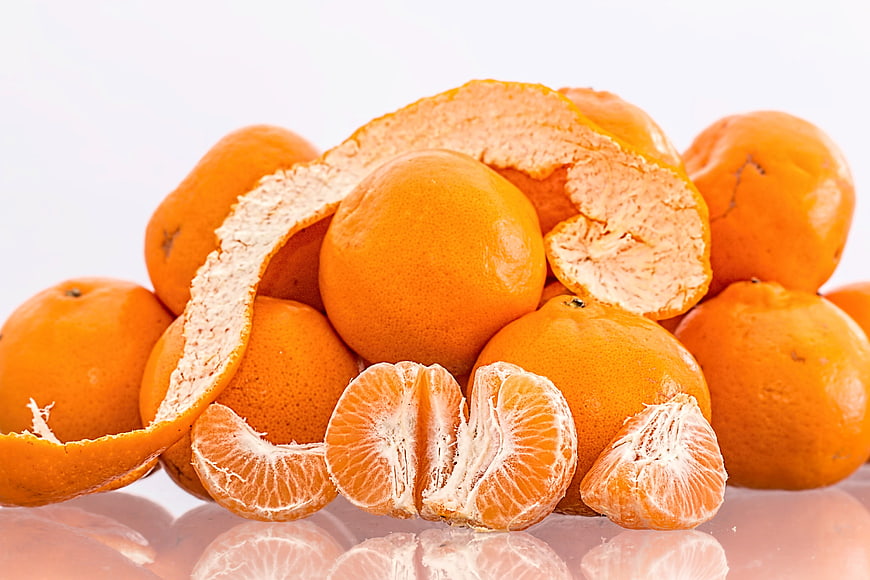 Fresh Mandarin Oranges and Segments on White Background