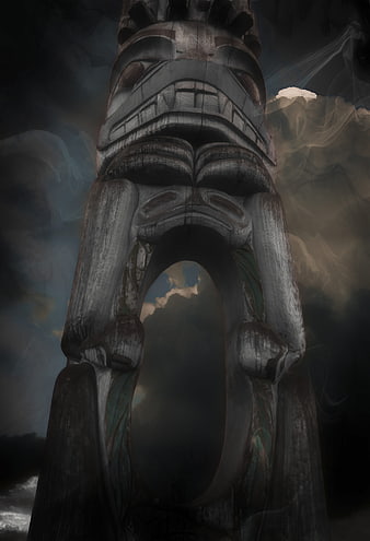 Dramatic Low Angle Totem Pole Sculpture Against Stormy Sky