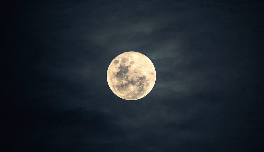 Full Moon in Dark Blue Night Sky with Clouds