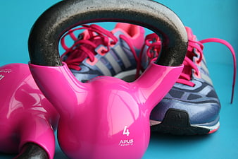 Pink Kettlebell and Running Shoes on Blue Background