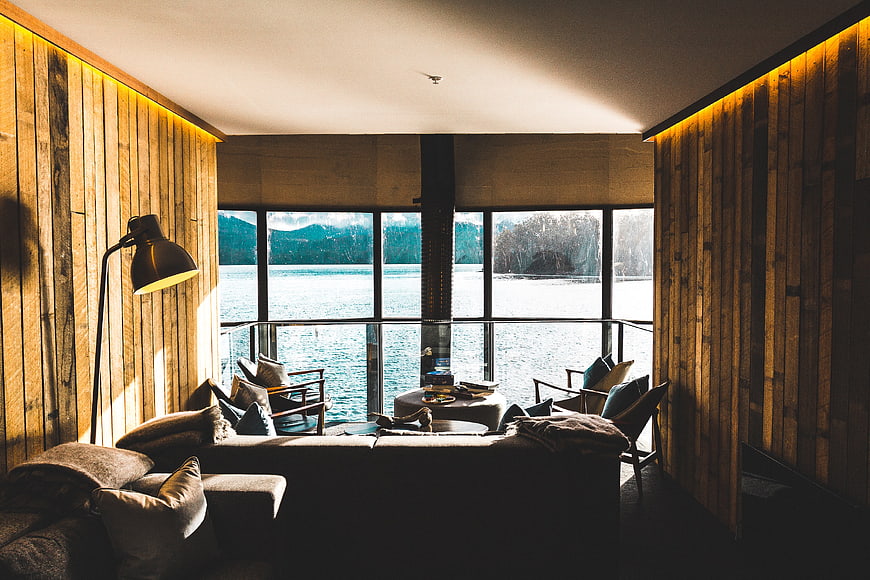 Modern wooden interior with lake view and cozy seating