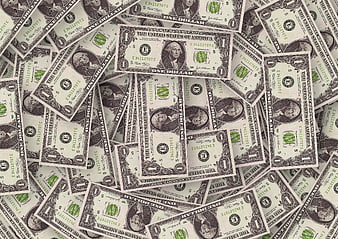 Scattered US One Dollar Bills Covering Surface