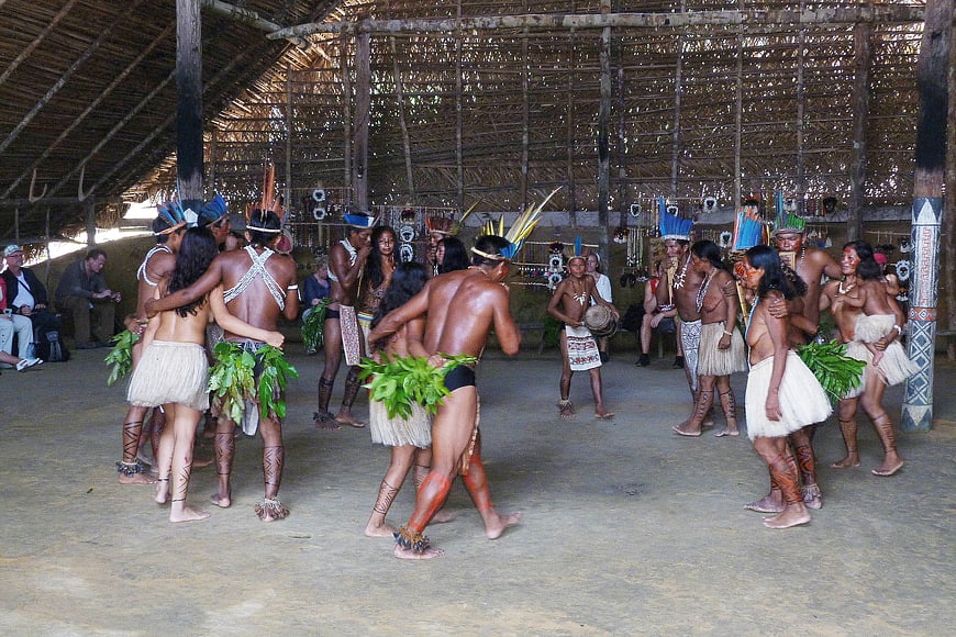 Indigenous Amazonian Tribe Performing Traditional Dance in Hut