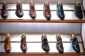 Display of Men's Leather Dress Shoes on Wooden Shelves
