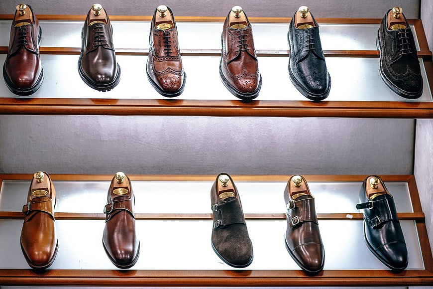 Display of Men's Leather Dress Shoes on Wooden Shelves