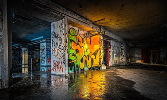 Colorful Graffiti in Abandoned Industrial Warehouse with Wet Floor