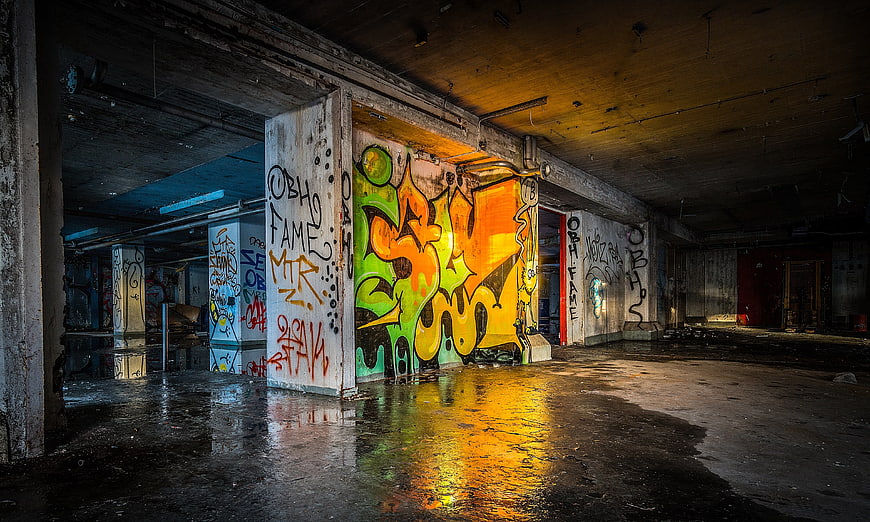 Colorful Graffiti in Abandoned Industrial Warehouse with Wet Floor