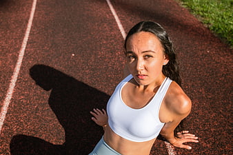 High Angle Portrait of Female Athlete Resting on Running Track