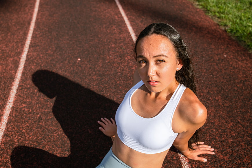 High Angle Portrait of Female Athlete Resting on Running Track