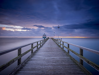 Long Exposure Wooden Pier at Blue Hour Over Calm Sea