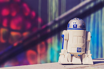 R2-D2 toy robot against colorful graffiti wall background