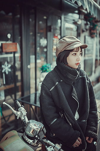 Woman in Vintage Cap Sitting on Motorcycle