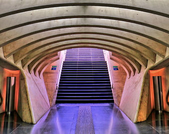 Modern concrete staircase with purple and orange lighting