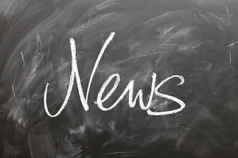 News written in white chalk on a blackboard background