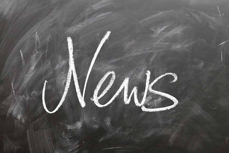 News written in white chalk on a blackboard background
