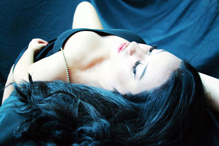 Sensual Portrait of Woman Lying Down with Closed Eyes