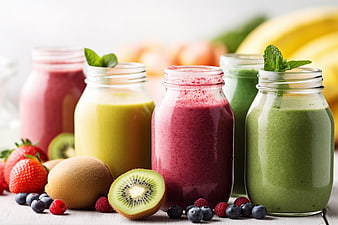 Colorful Fresh Fruit Smoothies in Glass Jars with Berries