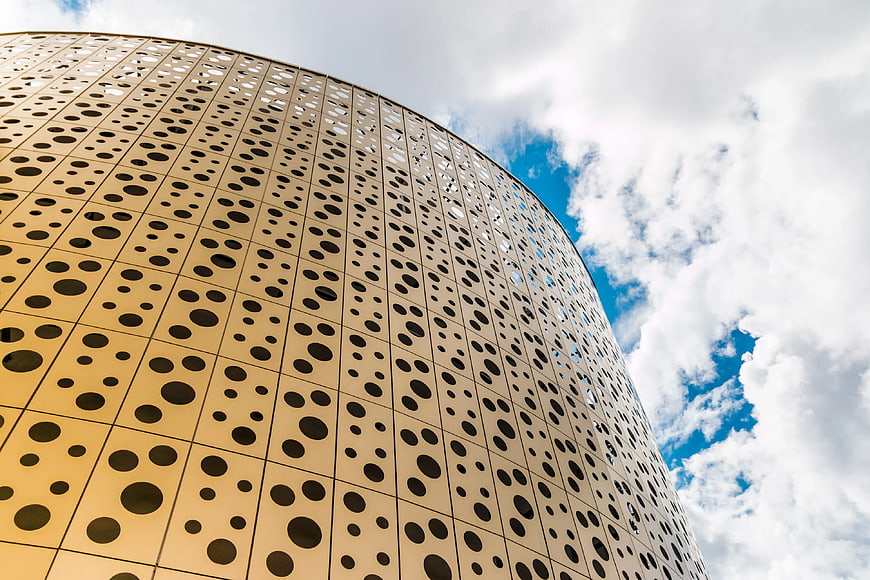 Low Angle View of Modern Perforated Metal Building Facade