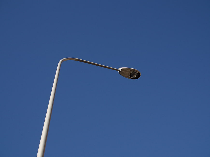 Modern street lamp against clear blue sky