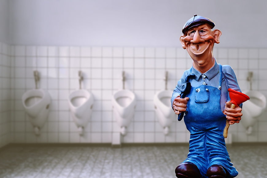 Plumber figurine with plunger in tiled bathroom