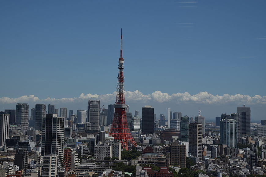 Tokyo Tower Rising Above Cityscape Under Blue Sky