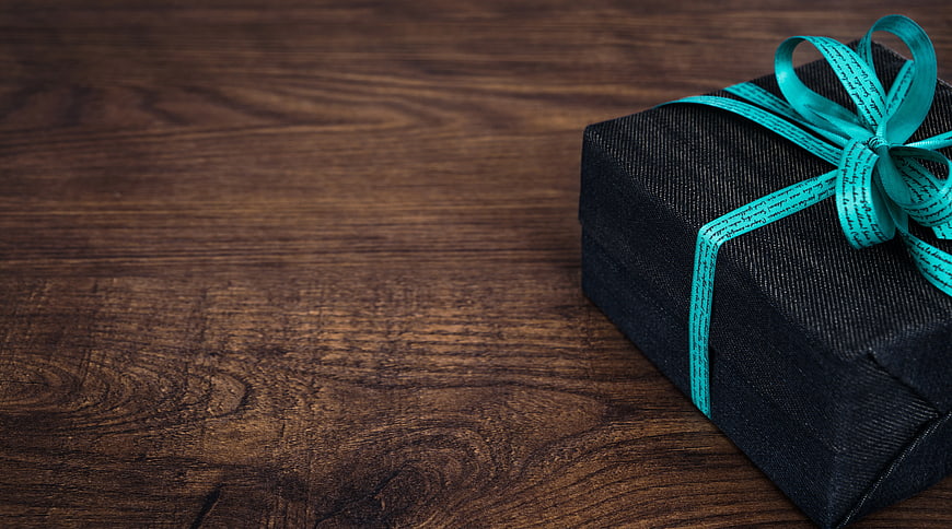 Black Gift Box with Teal Ribbon on Wooden Background