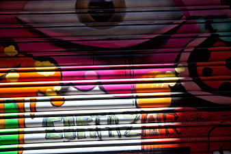 Colorful Graffiti on Metal Shutter with Shadows