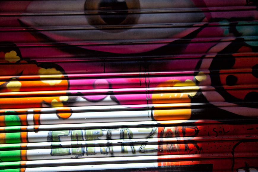 Colorful Graffiti on Metal Shutter with Shadows