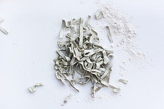 Fresh handmade pasta tagliatelle with flour on white background