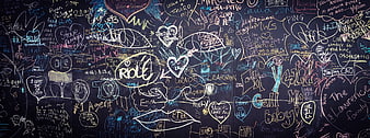 Colorful chalk graffiti on a dark blackboard wall