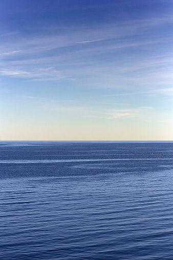 Serene Blue Ocean Horizon with Wispy Clouds